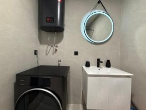 a bathroom with a sink and a mirror at Seafront apartment Tivat in Donja Lastva +10 photos