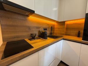 a kitchen with white cabinets and a counter top at Seafront apartment Tivat in Donja Lastva
