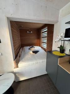 a bedroom with a bed in a brick wall at EstBerg Tartu Glasshouse with Sauna in Tartu