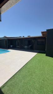 a house with a patio and green grass at Apartamento 4 - Refúgio do Descaso in São Francisco do Sul
