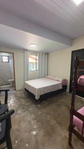 a bedroom with a bed and two windows at Apartamento 4 - Refúgio do Descaso in São Francisco do Sul