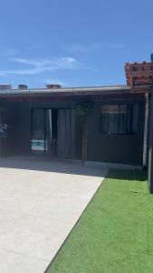 a house with green grass in front of it at Apartamento 4 - Refúgio do Descaso in São Francisco do Sul