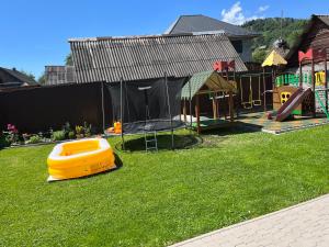 a backyard with a playground and a play set at Артемів двір in Slavske