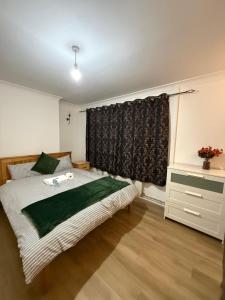 a bedroom with a bed and a window at Exquisite King-sized Bedroom - Free Parking in Dartford +4 photos