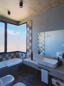 a bathroom with a tub and a sink and a toilet at CasaVid - Private Boutique Chalet & Spa - Vistas 360 in Tafí del Valle +29 photos