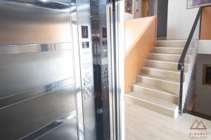 a metal elevator in a room with a staircase at Bakuriani - Didveli Gallery B212 in Bakuriani