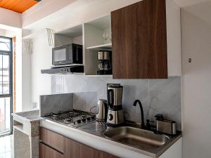 a kitchen with a sink and a stove top oven at Apartamento clásico Riosucio in Ruiosucio