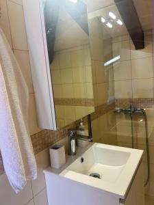 a bathroom with a sink and a mirror at Hestia loft in Nafplio