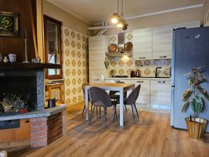 a kitchen with a table and chairs in a room at Dimora Paradise in Laglio