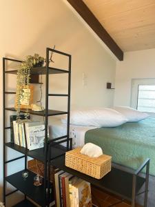 a bedroom with a book shelf next to a bed at Hestia loft in Nafplio