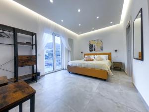 a bedroom with a bed and a large window at Delphi Soggiorni Romantic Suites with Private Terrace - Ischia Porto in Ischia Town