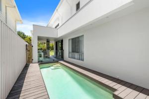 an external view of a house with a swimming pool at Beachfront Wellness Retreat in Kingscliff
