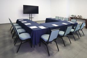 a long blue table and chairs in a room at Garner Hotel Mazatlan Beach by IHG in Mazatlán +77 photos