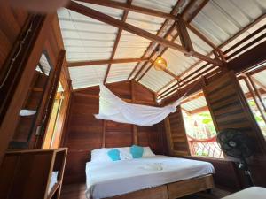 a bedroom with a bed in a room with a ceiling at La Bamba in Termales - agua caliente - nuqui +79 photos