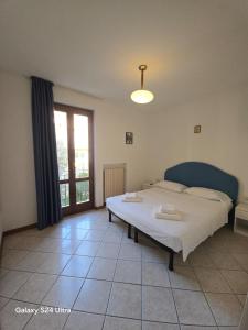 a bedroom with a bed and a large window at Appartamento A Limone in Limone sul Garda