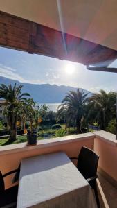 a window with a table and a view of the mountains at Appartamento A Limone in Limone sul Garda +2 photos