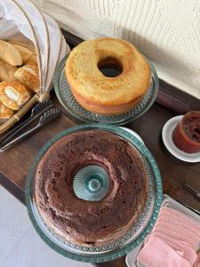 a table with two plates with a cake and a donut at Pousada do Coco in Abraão