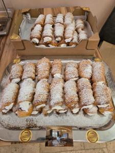 a bunch of donuts in boxes on a tray at Landhof Harrauer in Erlauf