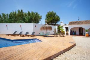 a patio with chairs and a swimming pool at Casa de campo Canoret, Benissa, Alicante , Spain in Benissa