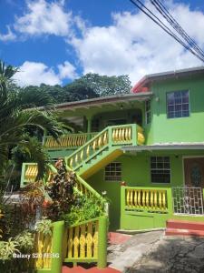 a green house with a staircase in front of it at Fano's Oasis in Castries