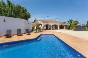 a villa with a swimming pool and a house at Casa de campo Canoret, Benissa, Alicante , Spain in Benissa