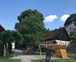 a playground in a yard next to a building at Chalupa V kopci in Vysoká Srbská
