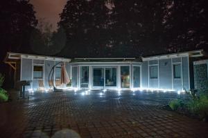 a house with a patio at night with lights at Bienenhaus in Sassnitz +12 photos