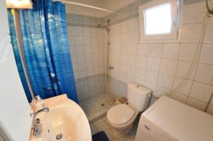 a bathroom with a toilet and a sink at Corfu Villa Ermioli with Pool in Giannádes +41 photos