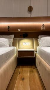 two beds sitting next to each other in a room at Luxurios seaside apartment 2 in Durrës +20 photos