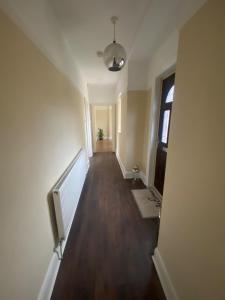 an empty hallway of an apartment with a television and a window at Spacious Dinnington bungalow in Dinnington