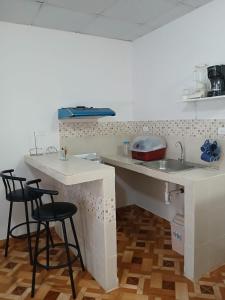 eine Küche mit zwei Barhockern und einem Spülbecken in der Unterkunft Apartamento Oderay in David