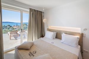 a bedroom with a large bed and a balcony at Penthouse Villa with Private Pool, Sauna & Seaview in Gialova +20 photos