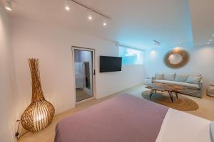 a living room with a couch and a table at Penthouse Villa with Private Pool, Sauna & Seaview in Gialova