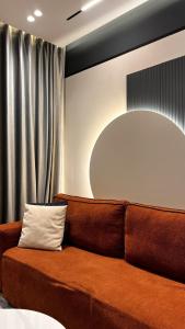 a brown couch in a room with a mirror at Noir luxury apartment in Durrës +23 photos