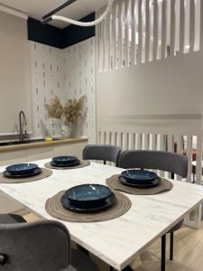a table with blue plates on it in a kitchen at Noir luxury apartment in Durrës