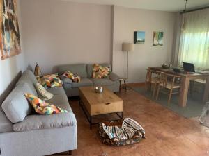 a living room with a couch and a table at Casa con encanto en Monachil in Monachil