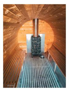 an inside of a sauna with a stove in it at Jurty i namioty w Lesie KotfaLas Glamping Świętokrzyskie-SPA in Skarżysko-Kamienna