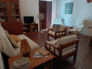 a living room with a couch and chairs and a table at Casa Terra & Cal in Moura
