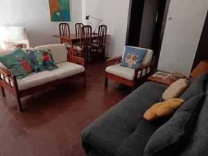 a living room with a couch and chairs and a table at Casa Terra & Cal in Moura