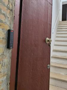 a brown door with a knob on it next to stairs at IN CENTRO apartments in Torre Maggiore
