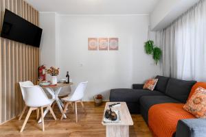 a living room with a couch and a table at Studio 35 - Modern & Cozy Studio in Chalandri City Center in Athens