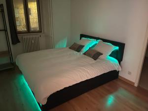 a bedroom with a bed with lights on it at L'Idéal in Guillestre