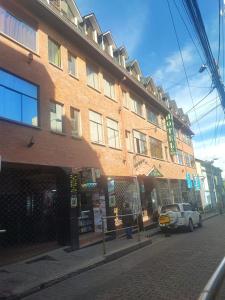 a building with a car parked in front of it at Hotel Savoy in La Paz