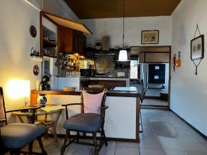 a kitchen with a table and some chairs and a table at Casa do Stefan in Lomba