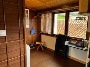 a small room with a table and a window at Casa do Stefan in Lomba +35 photos