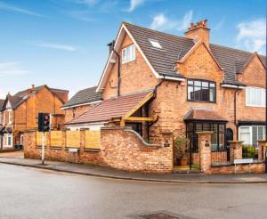 a brick house on the corner of a street at Ideal Stay for Business Travellers, Contractors, and Families near NEC, Belfry, Birmingham Resorts World, and Drayton Manor in Birmingham