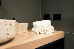 a pile of towels on a counter in a bathroom at The Flow - Via Del Corso in Rome