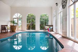 a swimming pool in a house with windows at Courthouse Merindah 4 in Daylesford