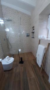 a bathroom with a shower and a toilet in it at Casas de Brisa in Calheta +98 photos