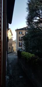 a street with a building and a tree next to a building at In Centro in Domodossola